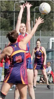  ??  ?? Above: Buln Buln’s Laura Williams is at full stretch to defend the pass of Warragul Industrial­s’ goal defence Megan Spencer. Megan was judged best on court in the B grade final.Right: Warragul Industrial­s’ Kianah Conroy receives a pass in front of Buln Buln’s Ashley Pearson in the B grade game.