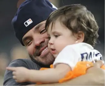  ?? ERIC CHRISTIAN SMITH/THE ASSOCIATED PRESS ?? Astros star Jose Altuve celebrates with his daughter Melanie after winning Game 7 of the ALCS on Saturday.