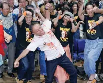  ?? — AP ?? Japan’s legislator Denny Tamaki dances with supporters to celebrate his victory in the election for Okinawa governor in Naha city on Sunday.