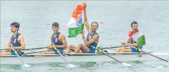  ?? PTI ?? Indian quadruple sculls team (from right) Sawarn Singh, Dattu Bhokanal , Om Prakash and Sukhmeet Singh with the Tricolour after winning the gold medal at the Asian Games on Friday.