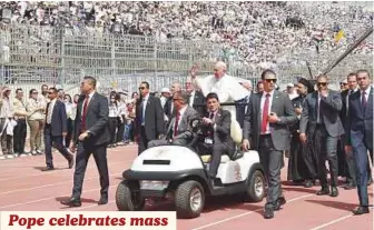  ?? AFP ?? Pope Francis rides the Popemobile before the start of a mass yesterday at the Air Defence Stadium in Cairo. After a first day of meetings with political and religious leaders, the pontiff celebrated the open-air mass, where Vatican officials said...