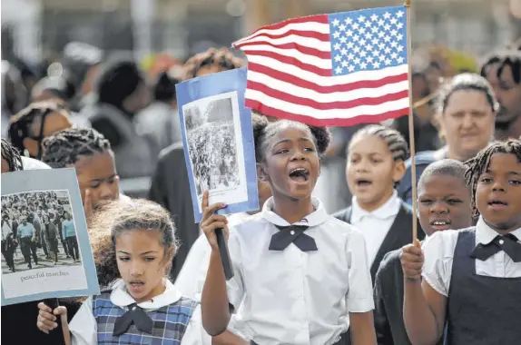  ?? K.M. Cannon Las Vegas Review-Journal @KMCannonPh­oto ?? Mirjhauni Jackson, center, marches in last year’s Dr. Martin Luther King Jr. parade in Las Vegas.