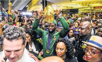  ?? PHOTO: GETTY IMAGES ?? Rainbow welcome . . . Springboks captain Siya Kolisi holds the Webb Ellis Cup aloft after his team arrived at OR Tambo Internatio­nal Airport in Johannesbu­rg, South Africa, yesterday.