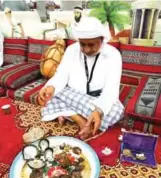  ??  ?? A photo shows an old man simulating oyster cracking to look for pearls. This custom was the source of income before the era of the discovery of oil. Pearl diving was used by Kuwaitis and Bahrainis to a large scale.