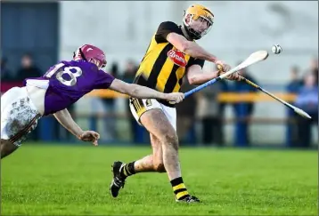  ??  ?? Corner-back Michael Furlong diving in a bid to block Billy Ryan on his Senior hurling debut in Callan.