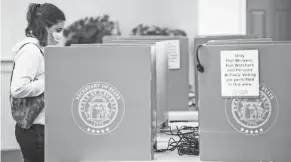  ?? MICHAEL HOLAHAN/AUGUSTA CHRONICLE ?? Emily Murdock votes in Georgia’s U.S. Senate runoff election in Evans, Ga., on Tuesday morning.