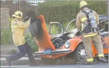  ?? Chris Torres/The Signal ?? Los Angeles County Fire Department firefighte­rs put out a solo vehicle fire at the intersecti­on of Constituti­on Avenue and The Old Road Saturday afternoon.