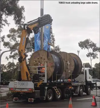  ??  ?? TOBCO truck unloading large cable drums.