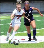  ?? (El Dorado News-Times/Penny Chanler) ?? Searcy’s Avery Meadows (left) tries to keep control of the ball Saturday as El Dorado’s Millee Mobley runs alongside during the Lady Lions’ 6-0 victory over the Lady Wildcats in the semifinals of the Class 5A girls soccer state tournament at Memorial Stadium in El Dorado.