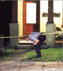  ?? DIGITAL FIRST MEDIA FILE PHOTO ?? A Pottstown police officer looks for clues at the scene of the Saturday stabbing in the 400 block of South Street.