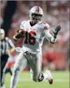  ?? ANDY MANIS — THE ASSOCIATED PRESS FILE ?? Ohio State quarterbac­k J.T. Barrett (16) scrambles against Wisconsin during the first half Saturday in Madison, Wis.