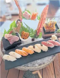  ?? ?? RIGHT
A large sushi platter showcasing prime seafood, including fatty tuna, hamachi, salmon, sea bass, Hokkaido scallop, ama ebi shrimp and uni.