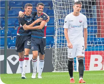  ??  ?? Ross County’s Ross Stewart celebrates making it 2-0 with teammate Brian Graham
