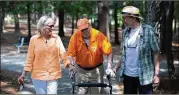  ?? BRANDEN CAMP / 2016 ?? Walter Chadwick, who was a star running back at the University of Tennessee, walks with friend and UT alum Ellen Morrison and former Wills High School football player Keith Miller in Laurel Park.
