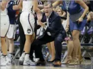  ?? JESSICA HILL — THE ASSOCIATED PRESS ?? Connecticu­t coach Geno Auriemma applauds during the first half of the team’s second-round game against Syracuse in the NCAA women’s college basketball tournament, Monday in Storrs, Conn.