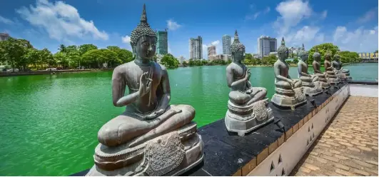  ??  ?? The view across the water from the Buddhist temple in Colombo. Below, Jamie Blake Knox takes to the road on a tuk-tuk