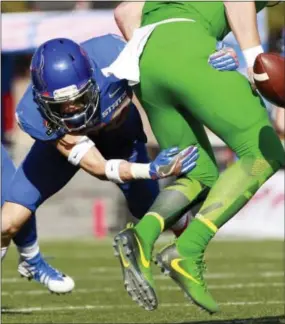  ?? JOE JASZEWSKI — THE ASSOCIATED PRESS ?? Boise State safety Kekaula Kaniho forces a first-half fumble against Oregon in the Las Vegas Bowl on Saturday.