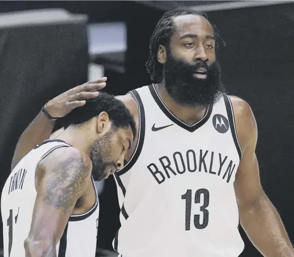  ??  ?? 0 Brooklyn Nets guard Kyrie Irving, left, gets a pat on the head from guard James Harden.