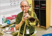  ?? BILL BANKS / FOR THE AJC ?? David Williams, who calls himself as “an old trombone player,” will retire this year after 34 years as band director at Renfroe Middle School in Decatur.