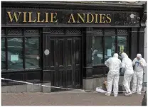  ??  ?? ABOVE: Forensics officers at the scene in the Pub Willie Andies on Friday night. Photo John Delea.
TOP: Patrick ‘Ginty’ O’Donnell’s coffin is moved from Ballindang­an Church for burial.