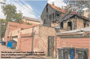  ?? MATTHEW HENDRICKSO­N/SUN-TIMES ?? The fire broke out about 4 a.m. Sunday in the second story of a building (center) in the 2200 block of South Sacramento.