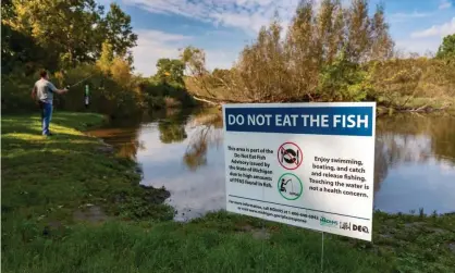  ?? Photograph: Jim West/Alamy ?? A sign at Island Lake State Recreation Area warns anglers not to eat fish from the Huron River due to high levels of PFAS chemicals.