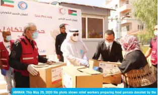 ?? — KUNA ?? AMMAN: This May 29, 2020 file photo shows relief workers preparing food parcels donated by the Kuwait Red Crescent Society to Syrian refugees in Amman, Jordan.
