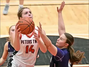  ?? Justin Guido photos/For the Post Gazette ?? Peters Township’s Natalie Wetzel shots the ball over Baldwin’s Libby Michalski in a game Monday at Peters Township High School. View more photos at Post-Gazette.com.