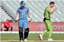  ?? GETTY IMAGES ?? Adam Milne (right) is feeling the pain after his fingertip run out of Travis Head (left) at the bowler’s end of a Big Bash match in Adelaide.