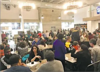  ?? Dan Gigler/Post-Gazette ?? Diners enjoy an evening on a busy Saturday night at Federal Galley on the North Side.