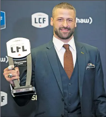  ?? THE CANADIAN PRESS ?? Edmonton Eskimos quarterbac­k Mike Reilly, recipient of the Most Outstandin­g Player award, poses backstage at the CFL awards in Ottawa last night.