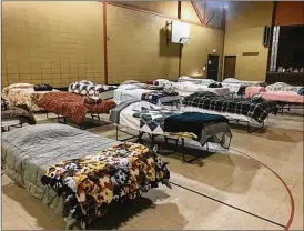  ?? GABRIELLE ENRIGHT PHOTOS / STAFF ?? The shelter has 20 beds, but can hold up to 100 people. Those who stay have access to a bed, clothes and food. Guests get dinner, breakfast and lunch to take with them when they leave the next morning. To get a bed, guests must show valid ID and pass a...