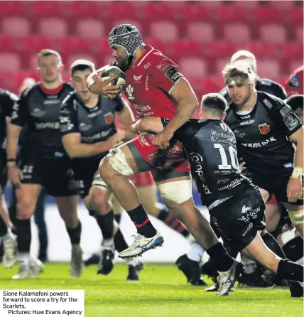  ??  ?? Sione Kalamafoni powers forward to score a try for the Scarlets.
Pictures: Huw Evans Agency