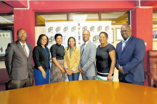  ?? CONTRIBUTE­D PHOTOS ?? Youngest-ever student, 14 year-old Jada Wright (centre), and her mother Judian Wright (third left) share a photo with President, University of Technology, Jamaica, Dr Kevin Brown (third right) and other members of the university’s management team (from left) David White, head, School of Computing and Informatio­n Technology; Marion Brown, vice-president and university registrar; Professor Shermaine Barrett, acting deputy president, and Professor Sean Thorpe, dean, Faculty of Engineerin­g and Computing.