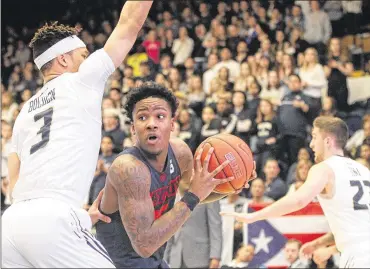  ?? DAVID JABLONSKI / STAFF ?? Dayton’s John Crosby looks for a shot Saturday against George Washington’s Jair Bolden. The Colonials finished the regular season with a five-game winning streak.