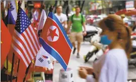  ?? Hau Dinh Associated Press ?? NORTH KOREAN and U.S. f lags are displayed for sale in Hanoi. Vietnam is one of the few nations that has good relations with both Pyongyang and Washington.