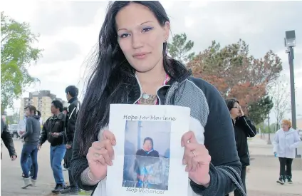  ?? TYLER CLARKE/ PRINCE ALBERT DAILY HERALD ?? Marlene Bird’s niece Jamie Bird holds up a picture of her aunt at a June 6 March for Peace through downtown Prince Albert. Marlene, a homeless residentia­l school survivor, was found severely injured in a Prince Albert parking lot on June 1.