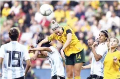  ?? — AFP photo ?? Australia’s Alanna Kennedy (centre) heads the ball into the net to score against Argentina during their Women’s Cup of Nations football match in Melbourne.