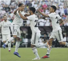  ?? AFP ?? Real Madrid substitute Marco Asensio, centre, celebrates after scoring one of his two goals in the friendly against Juventus