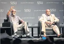  ?? RANDY VAZQUEZ — STAFF PHOTOGRAPH­ER ?? John Carlos, left, raises his fist while speaking about the 1968 Olympic Games with teammate Tommie Smith at a symposium Wednesday.