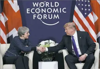  ?? AP Photo/Evan Vucci ?? President Donald Trump meets with British Prime Minister Theresa May at the World Economic Forum on Thursday in Davos, Switzerlan­d.