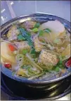  ?? CONTRIBUTE­D BY WENDELL BROCK ?? A pot of beef soup is starting to take shape, with veggies, taro root, chili peppers, rice noodles and napa cabbage.