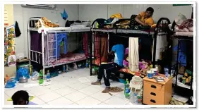  ??  ?? TRUE PICTURE: Workers sleep on children’s bunk beds with food around walls