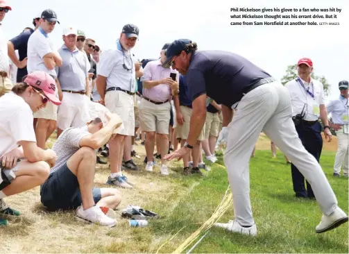  ?? GETTY IMAGES ?? Phil Mickelson gives his glove to a fan who was hit by what Mickelson thought was his errant drive. But it came from Sam Horsfield at another hole.
