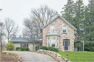  ?? SUTTON HEADWATERS REALTY PHOTOS ?? This two-storey detached stone house features a covered side porch, a restored belvedere, Victorian trim, stone work around high windows and a main floor extension with wood siding.