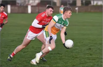  ??  ?? Andrew Mooney of Louth closes in on Offaly’s David Dempsey.