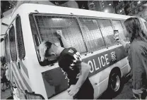 ??  ?? An antiExtrad­ition bill supporter punches a police van after police detained protesters near a Sai Wan Ho Mass Transit Railway (MTR) station in Hong Kong, China, August 11, 2019. (Reuters)