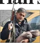  ??  ?? KILLED: Dhar, with an automatic rifle and his newborn son in Syria in 2014