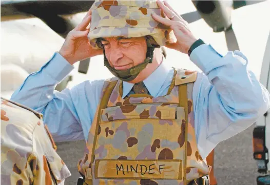  ??  ?? Then defence minister Robert Hill, on his way to Iraq in 2004.