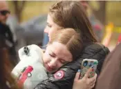  ?? AP PHOTO/DAVID ZALUBOWSKI ?? Two women hug after a school shooting Wednesday at East High School in Denver.